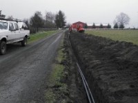 Power trench for driveway gate